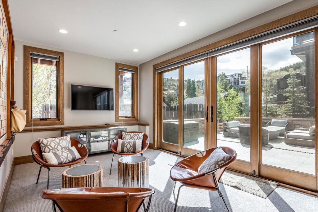 Living room featuring healthy amount of natural light, recessed lighting, carpet floors, and baseboards