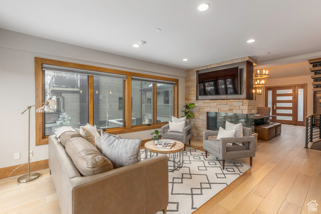 Living area featuring light wood-type flooring, recessed lighting, and a fireplace