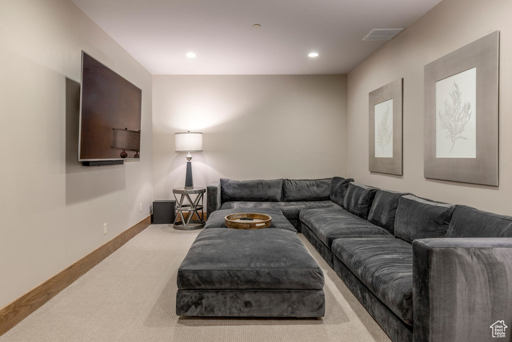 Living room featuring carpet flooring, baseboards, and recessed lighting