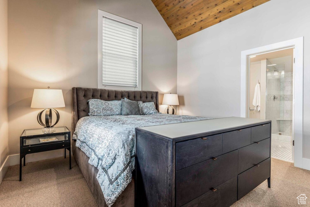 Bedroom with vaulted ceiling, wood ceiling, carpet, baseboards, and ensuite bath