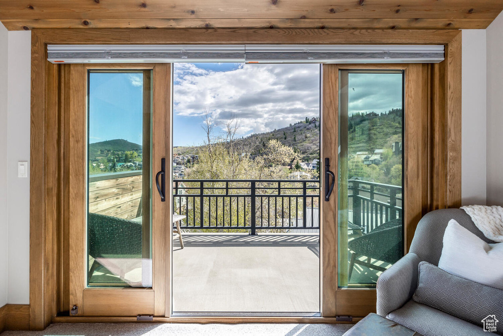 Doorway with a mountain view and carpet