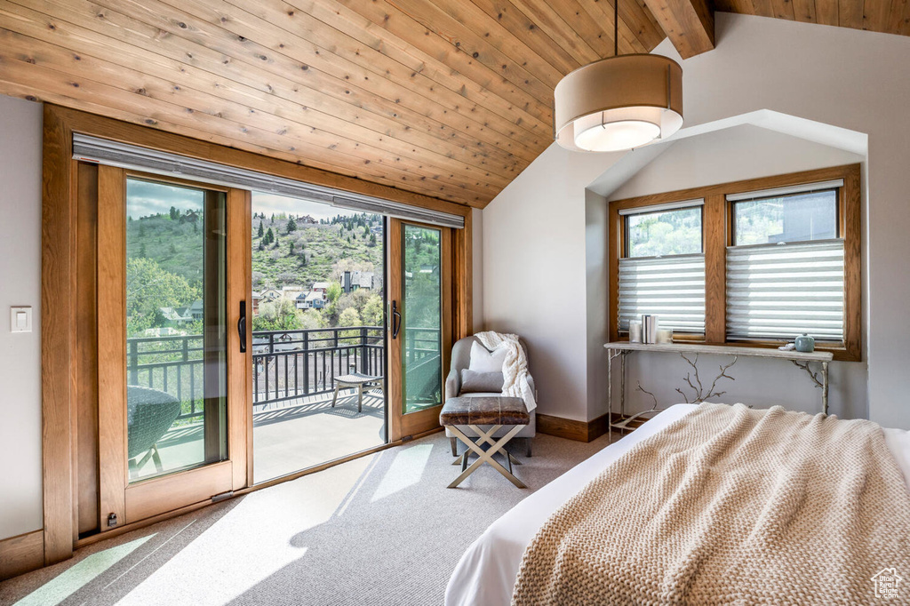 Bedroom with access to outside, carpet, and wood ceiling