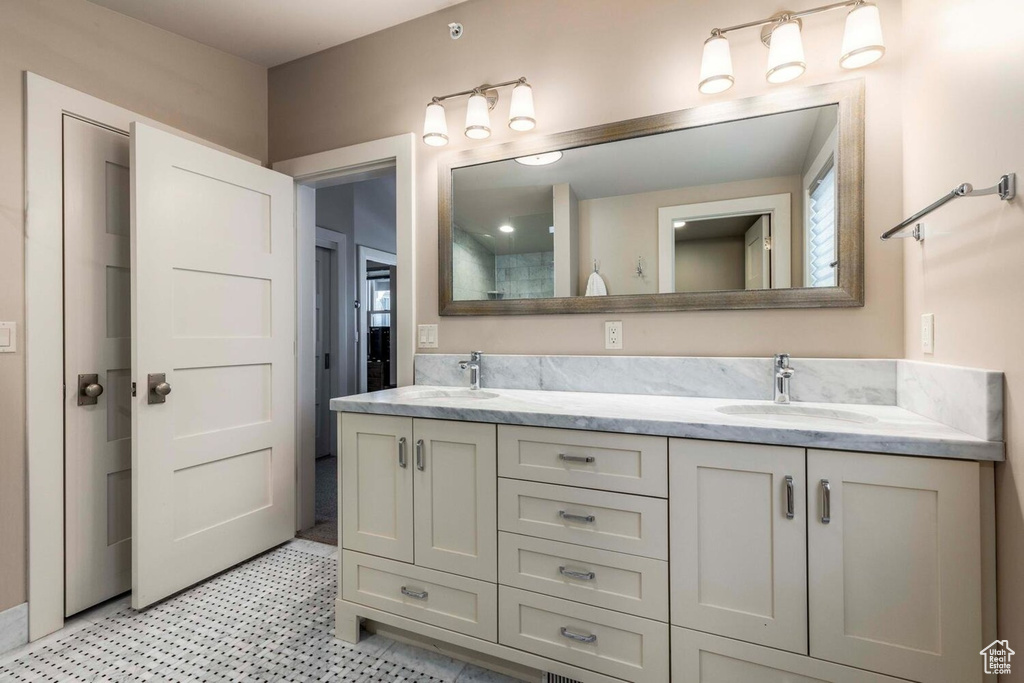 Bathroom featuring double vanity and tile patterned floors