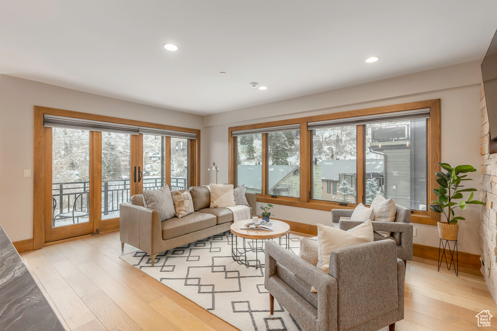 Living area with light wood-style flooring, baseboards, recessed lighting, and french doors