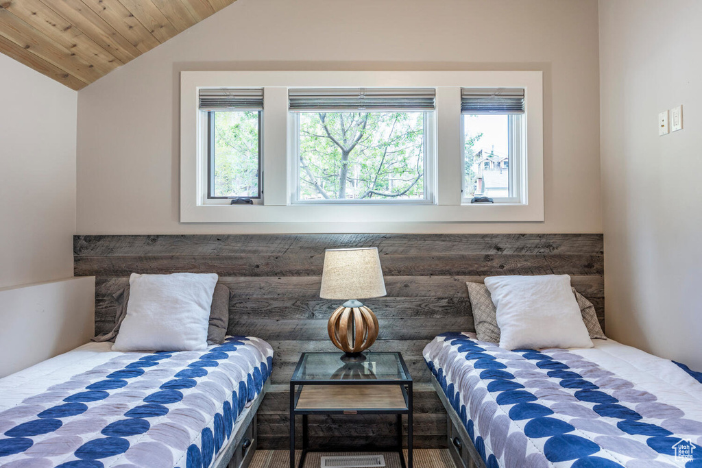 Bedroom with lofted ceiling and wood ceiling
