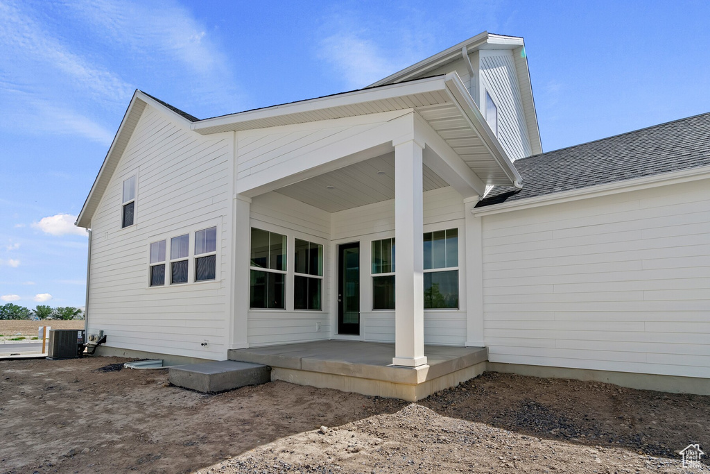 Back of property featuring cooling unit