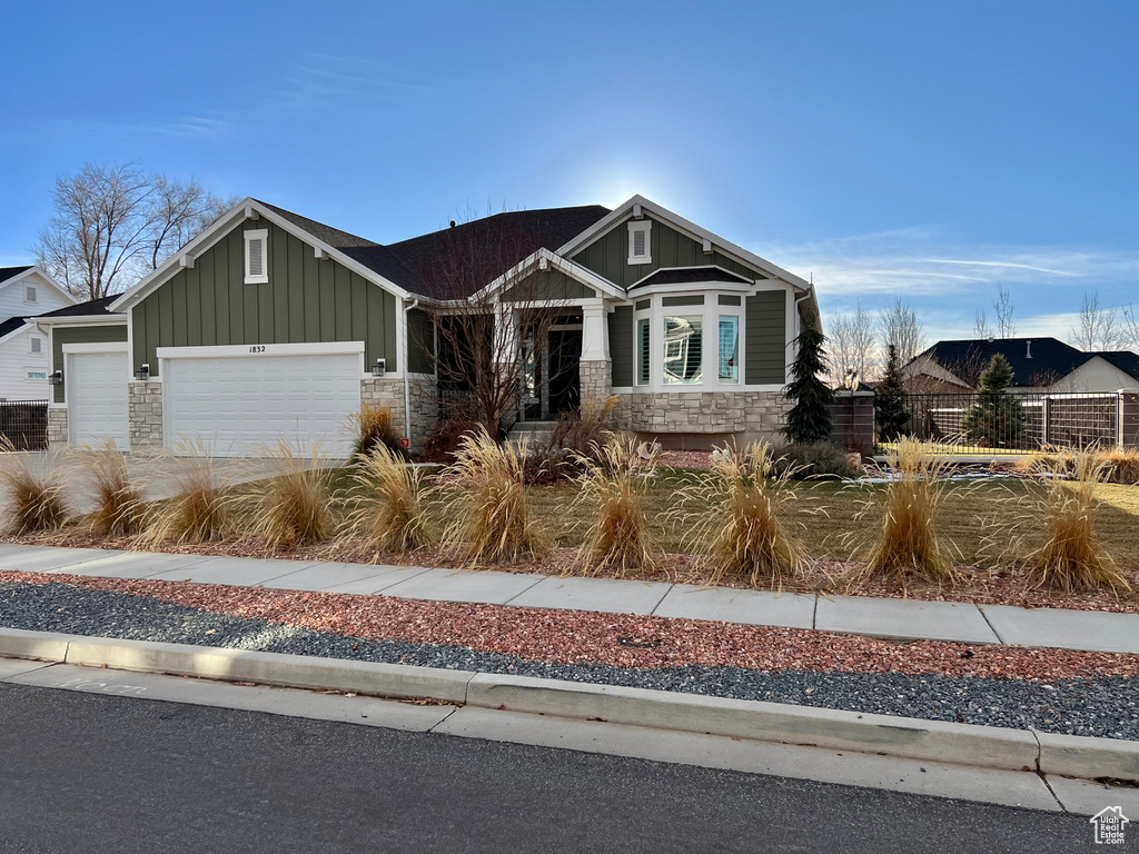 Craftsman house featuring a garage