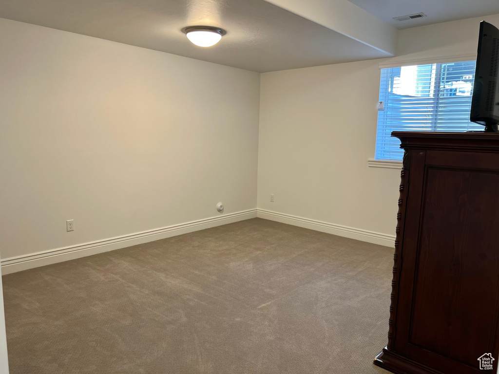 Empty room with carpet flooring
