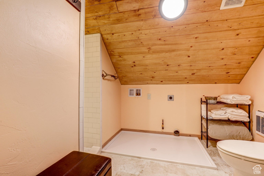 Bathroom featuring a shower, lofted ceiling, wooden ceiling, tile patterned flooring, and toilet