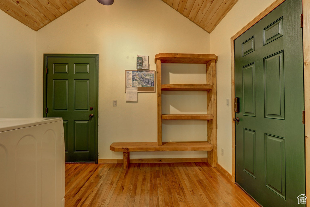 Foyer entrance with washer / clothes dryer, vaulted ceiling, and wood ceiling