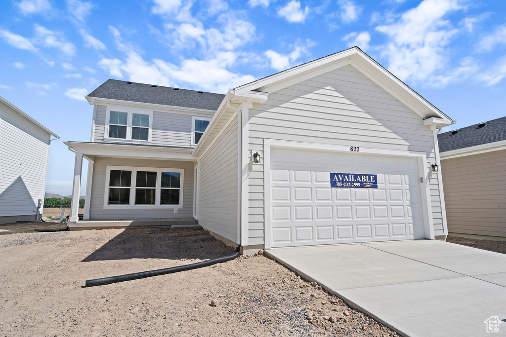 View of front of home featuring driveway and an attached garage