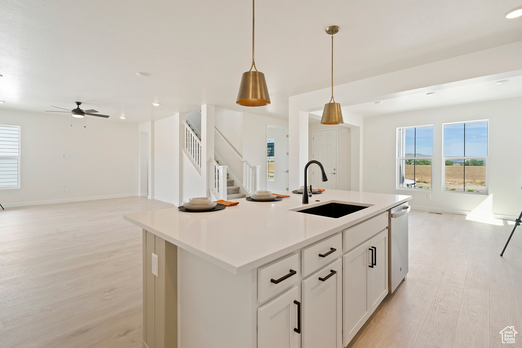 Kitchen featuring a sink, light wood-style floors, open floor plan, a ceiling fan, and recessed lighting