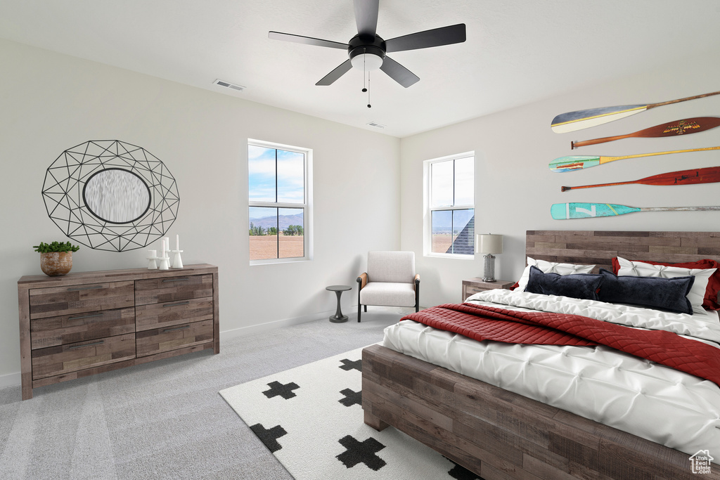 Carpeted bedroom with baseboards and a ceiling fan