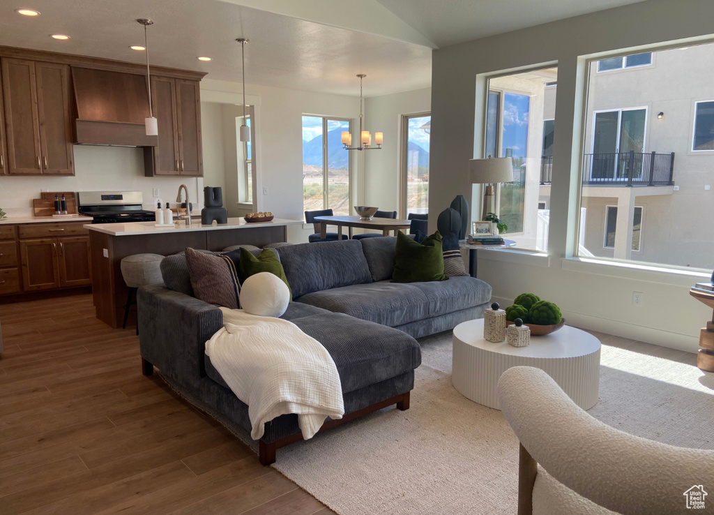 Living room with dark hardwood / wood-style floors and an inviting chandelier
