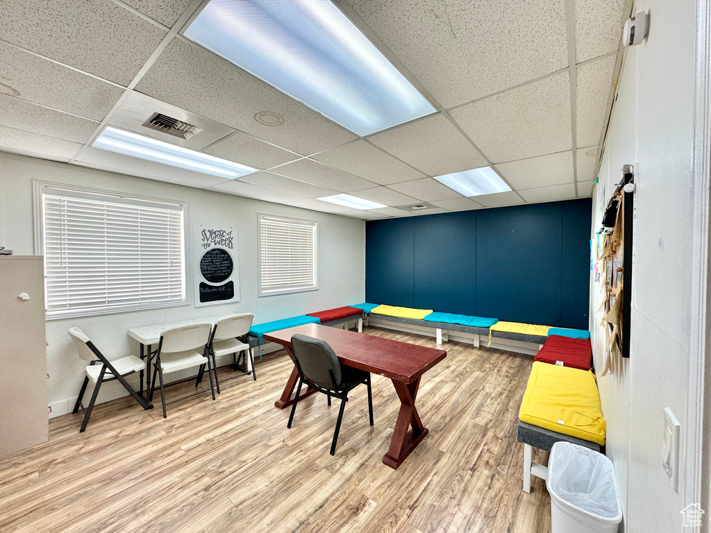 Game room with a drop ceiling and wood finished floors