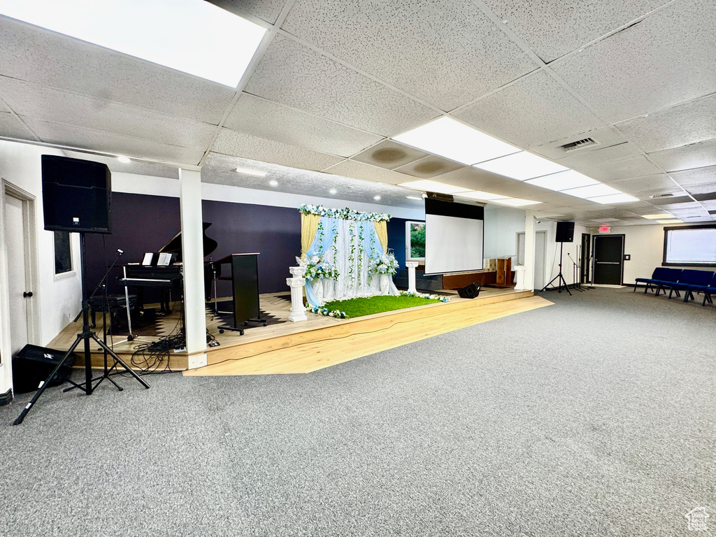 Basement featuring carpet and a paneled ceiling