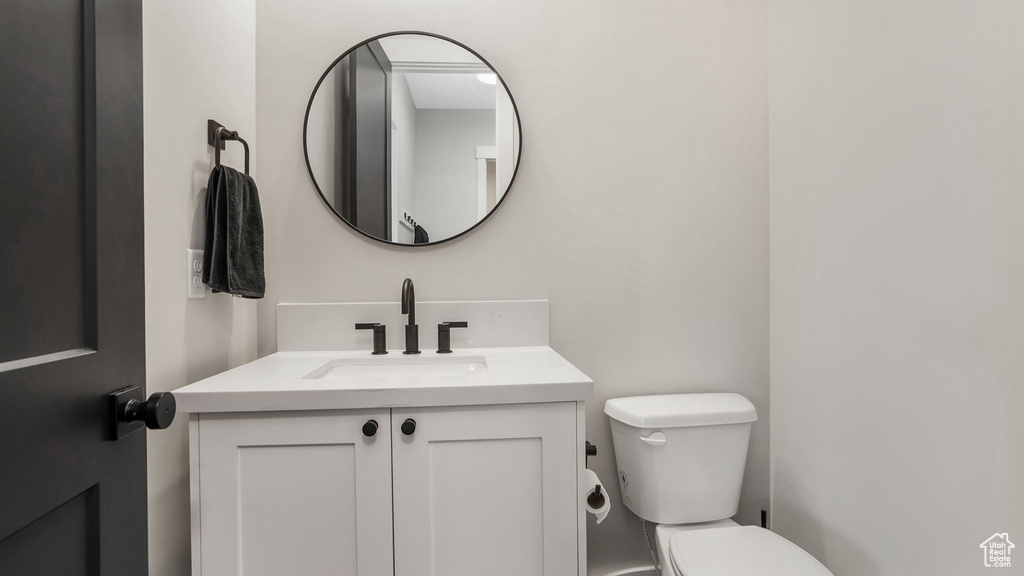 Half bathroom with vanity and toilet