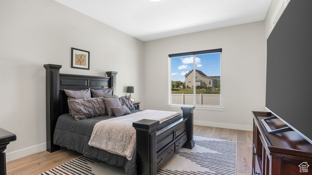 Bedroom with light wood-style flooring and baseboards