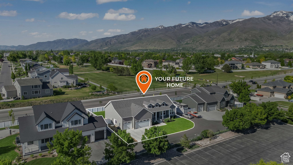 Aerial perspective of suburban area featuring a mountainous background and property parcel outlined