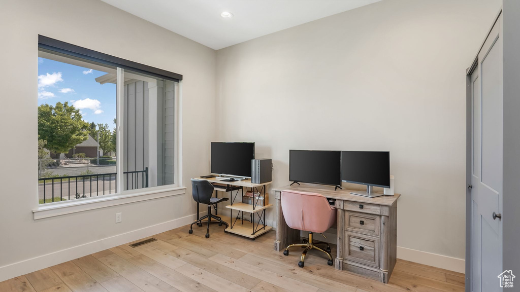 Home office featuring baseboards, hardwood / wood-style floors, and recessed lighting