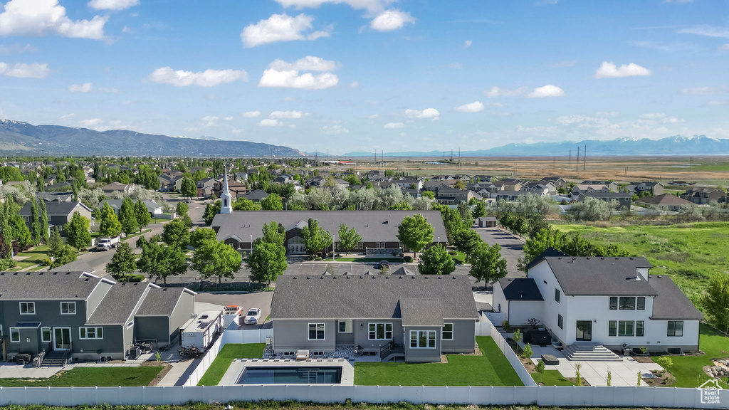 Aerial perspective of suburban area featuring a mountainous background