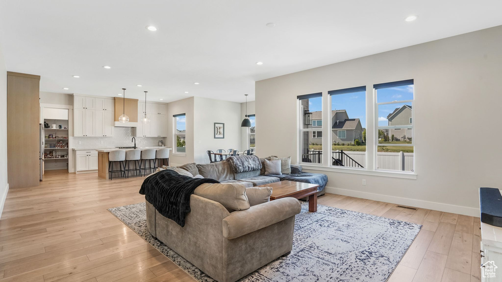 Living area featuring recessed lighting, light wood-type flooring, and baseboards