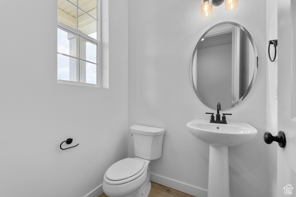 Bathroom featuring baseboards and toilet