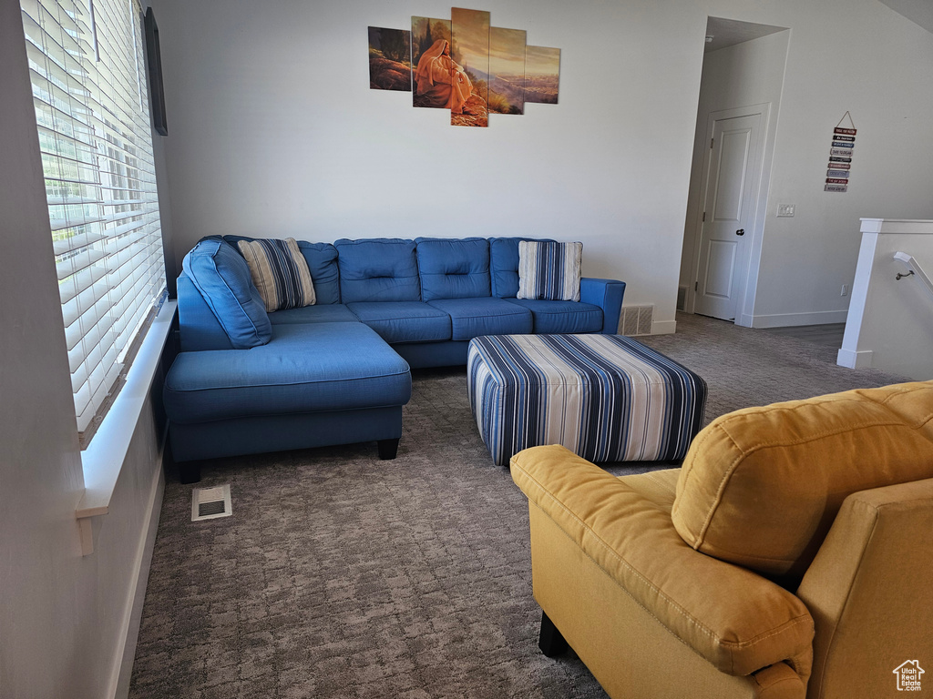 Carpeted living area with baseboards