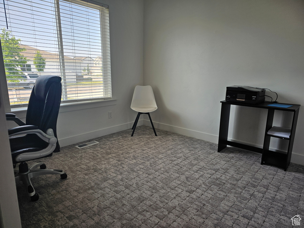 Office area featuring carpet and baseboards