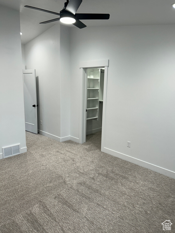 Carpeted empty room with ceiling fan