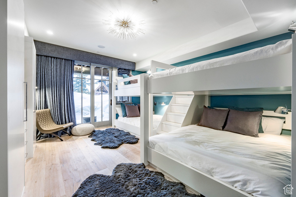 Bedroom with wood finished floors and access to exterior