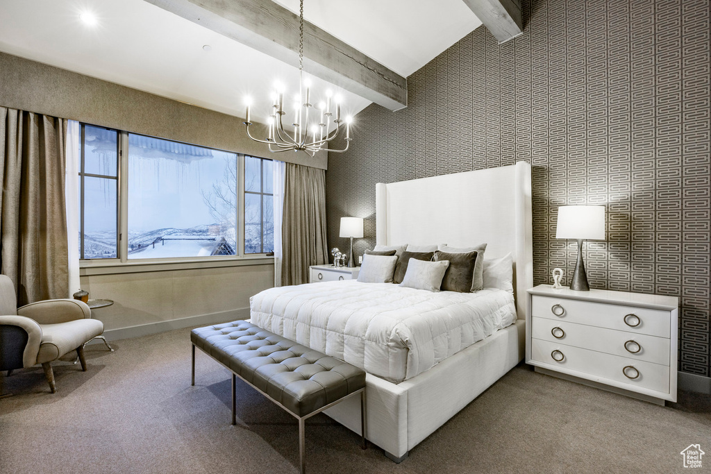 Carpeted bedroom with a chandelier