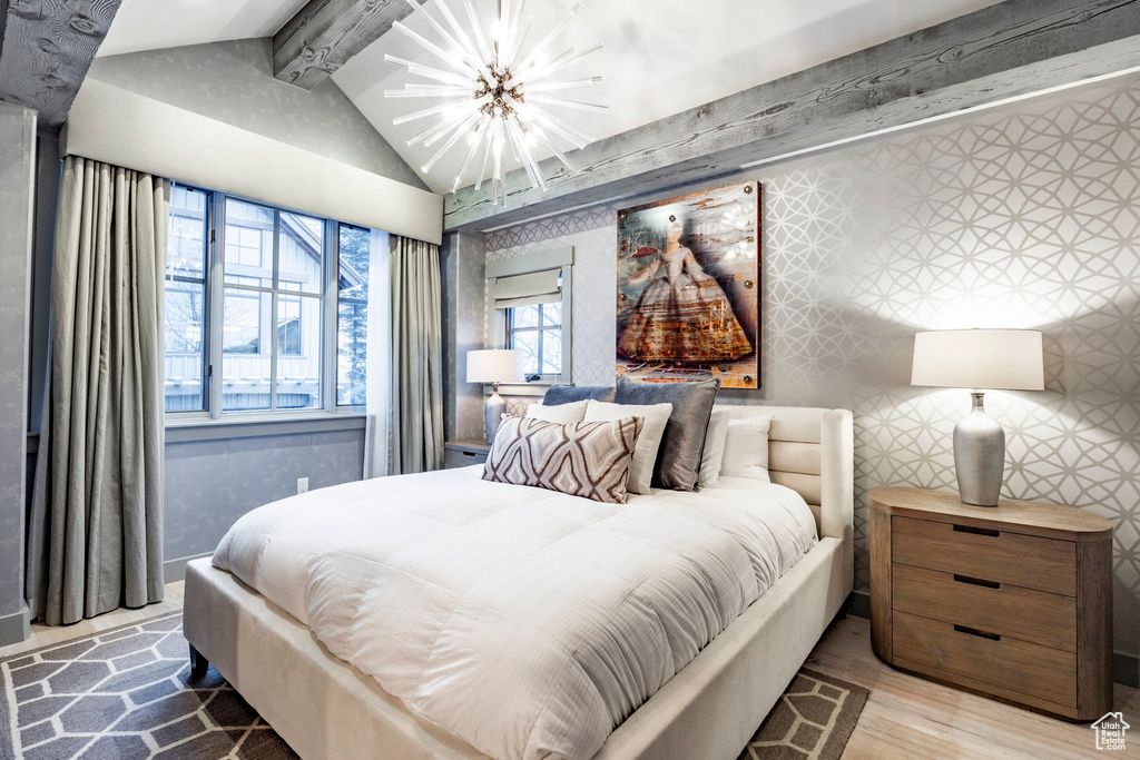 Bedroom featuring a chandelier and wood finished floors