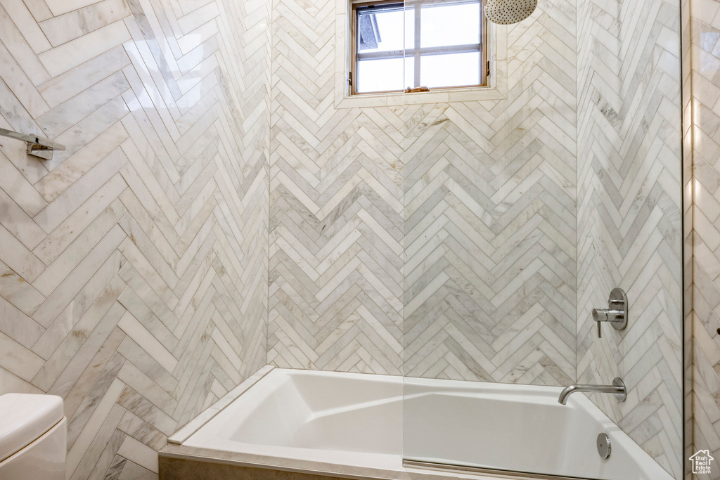 Bathroom with bathing tub / shower combination and toilet