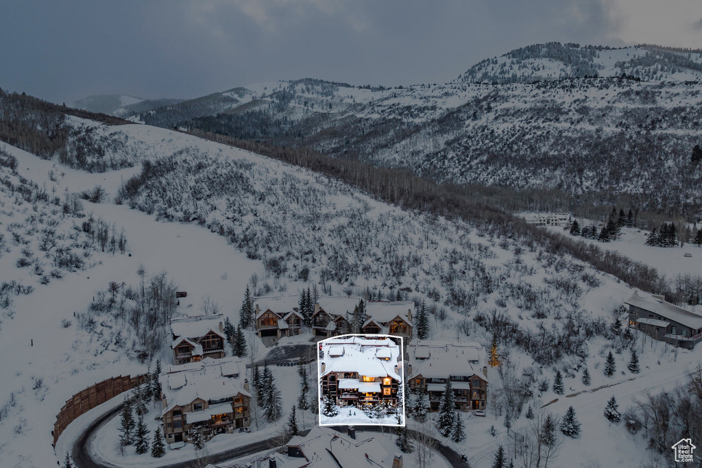 Snowy aerial view featuring a mountain view