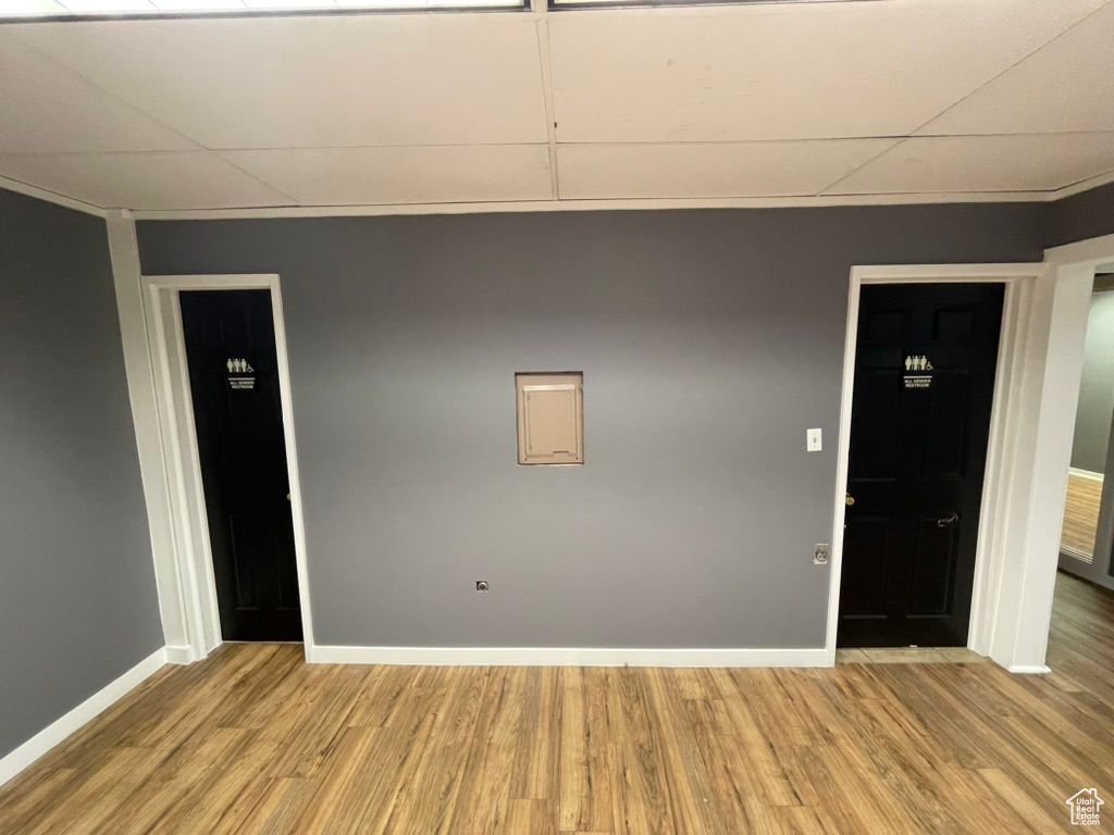 Spare room featuring a drop ceiling and light hardwood / wood-style floors