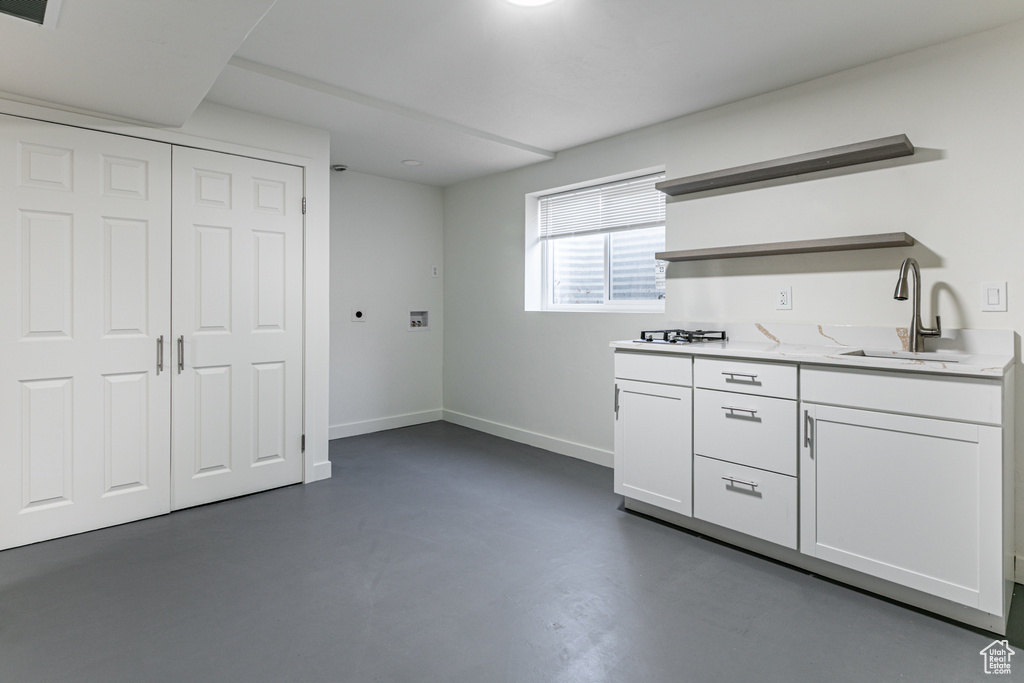 Kitchen featuring white cabinets and sink