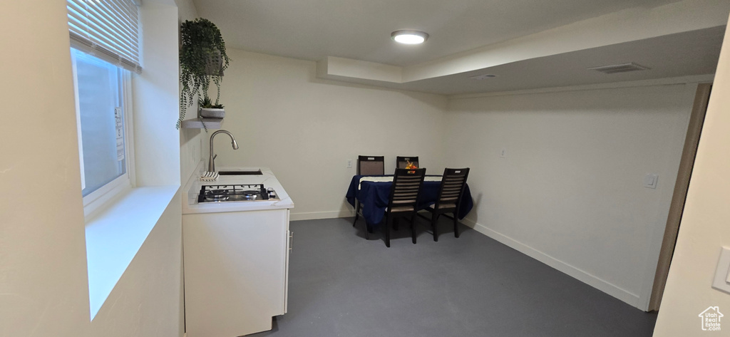 Office space featuring sink and concrete flooring