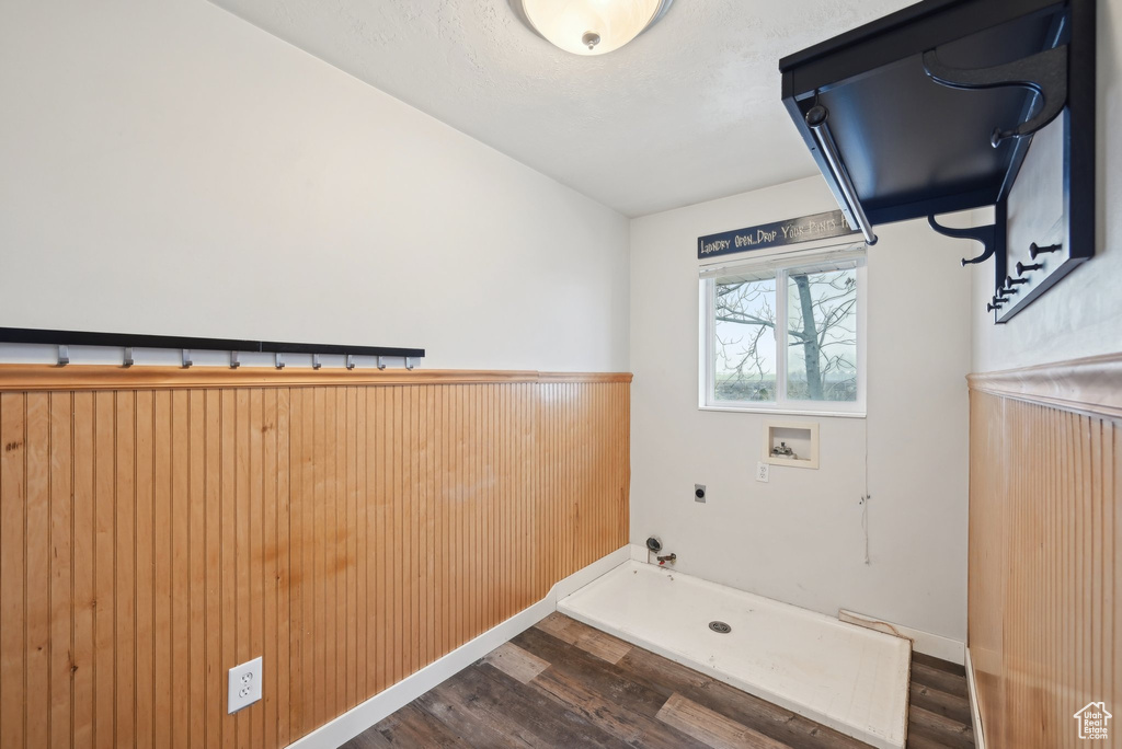 Washroom with hookup for an electric dryer, hookup for a gas dryer, laundry area, dark wood-type flooring, and washer hookup