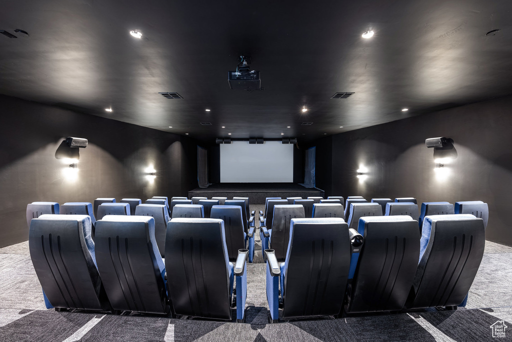 Carpeted home theater room with recessed lighting