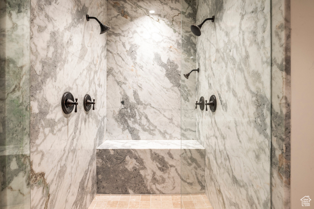Bathroom featuring a marble finish shower