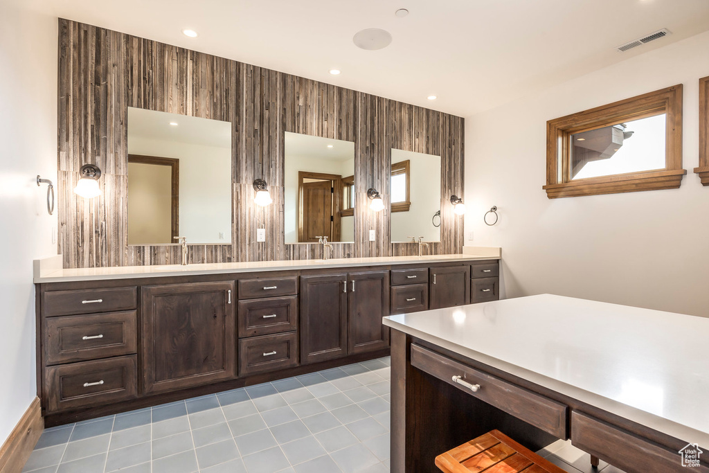 Full bathroom with double vanity and recessed lighting