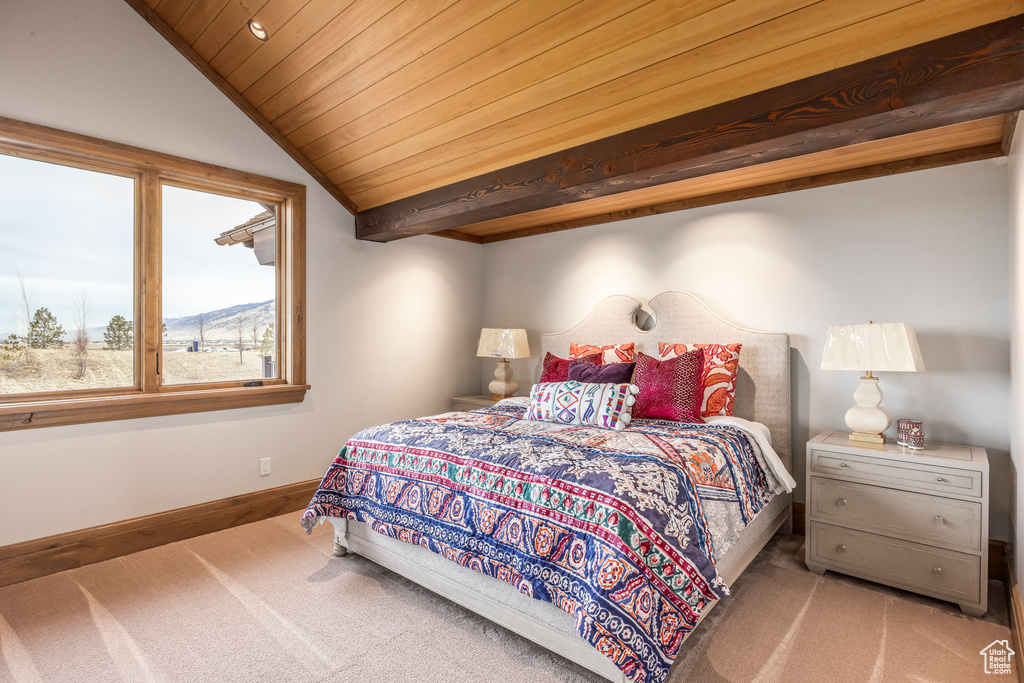 Carpeted bedroom featuring lofted ceiling and wooden ceiling