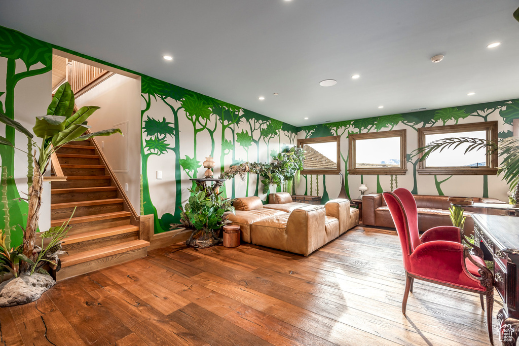 Living area featuring hardwood / wood-style flooring, stairs, recessed lighting, and wallpapered walls