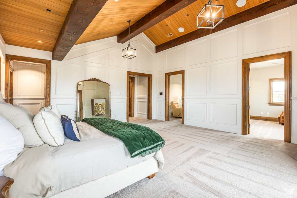 Bedroom with a decorative wall, a chandelier, wooden ceiling, and light carpet