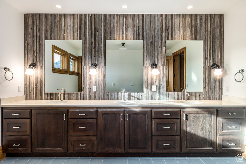 Bathroom featuring double vanity, tile patterned flooring, and recessed lighting