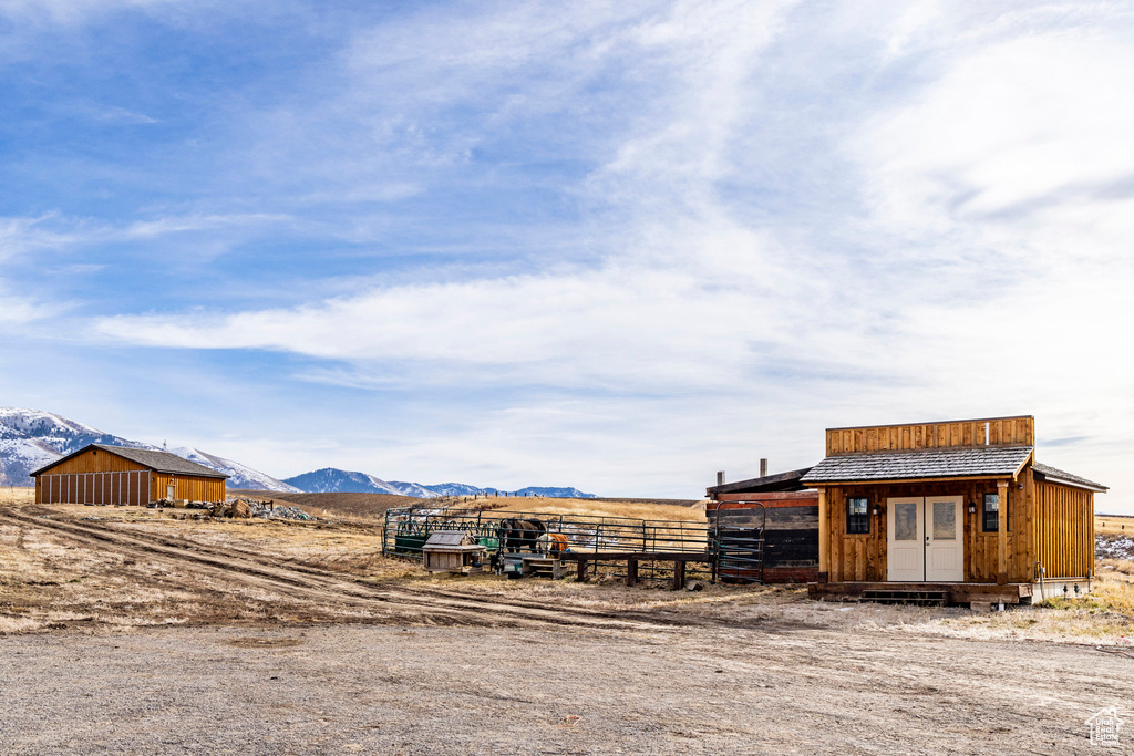 View of yard featuring a mountain view and an outdoor structure