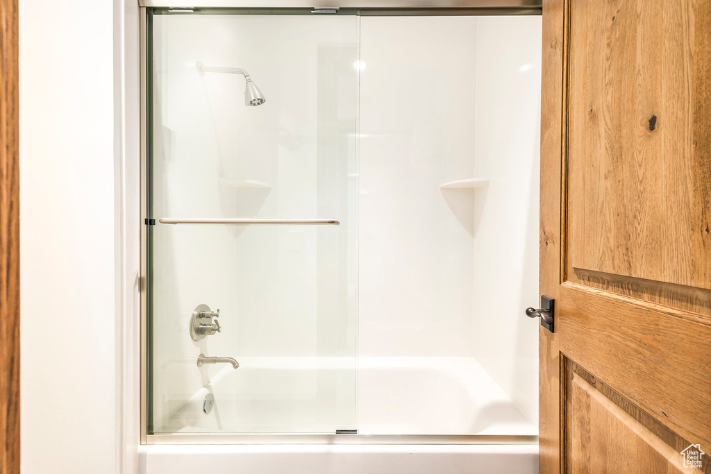 Full bathroom featuring bath / shower combo with glass door