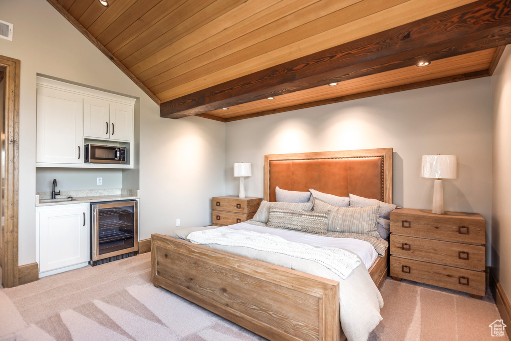 Bedroom with wine cooler, light carpet, wet bar, and wooden ceiling