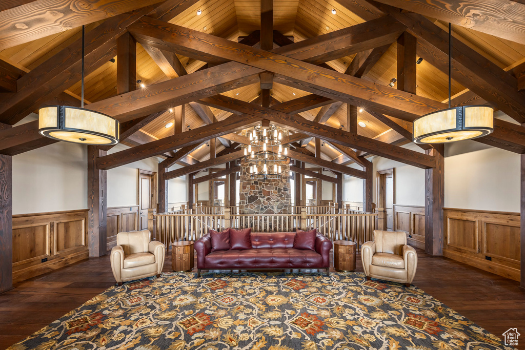 Living area with a wainscoted wall, dark wood-type flooring, and a decorative wall
